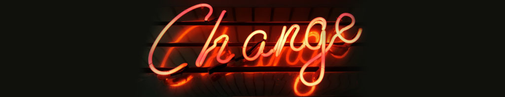 A neon sign that says " change ".