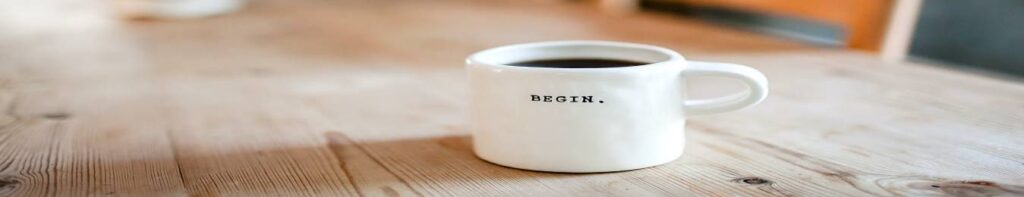 A cup of coffee that says " begin ".
