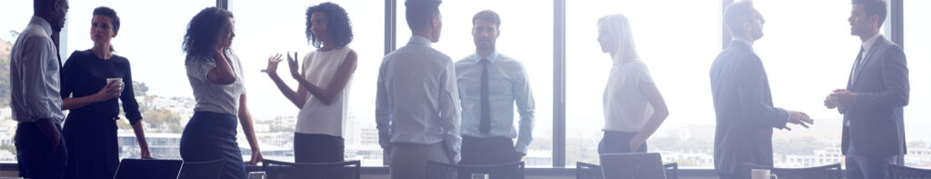 Two men standing in front of a window